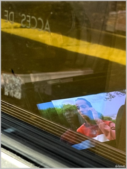 Dans la vitre d'un TGV, le reflet de l'écran d'ordinateur du siège de devant